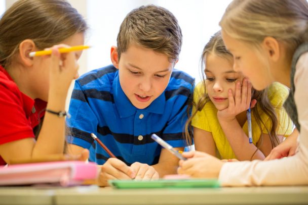 group of students talking and writing at school